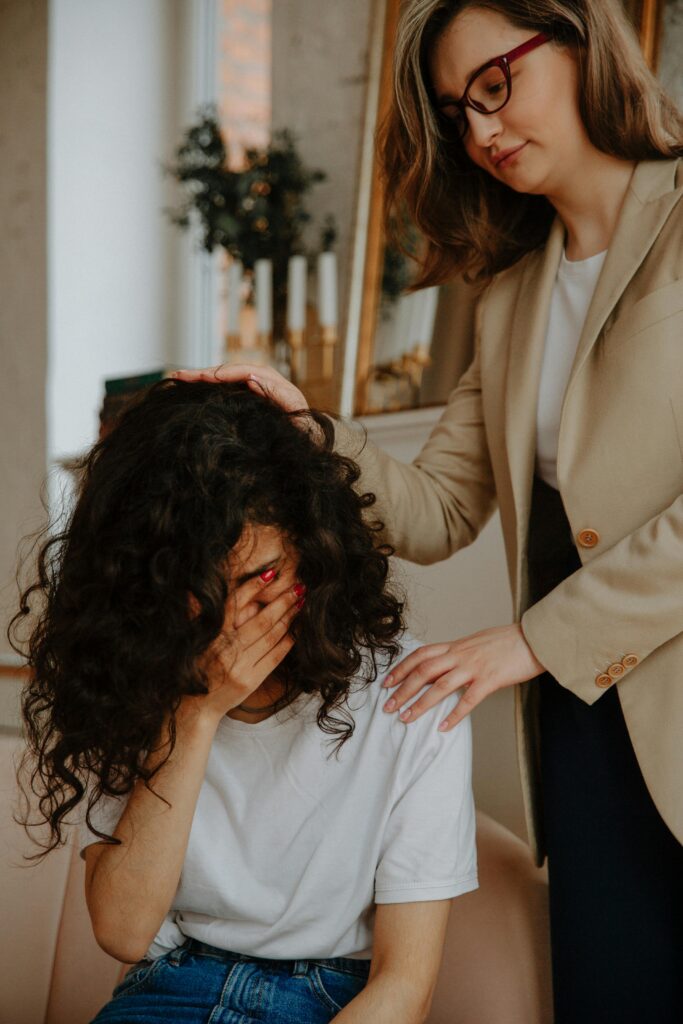 pexels photo 3958412 3958412 A young woman receiving comforting support during an emotional therapy session indoors.